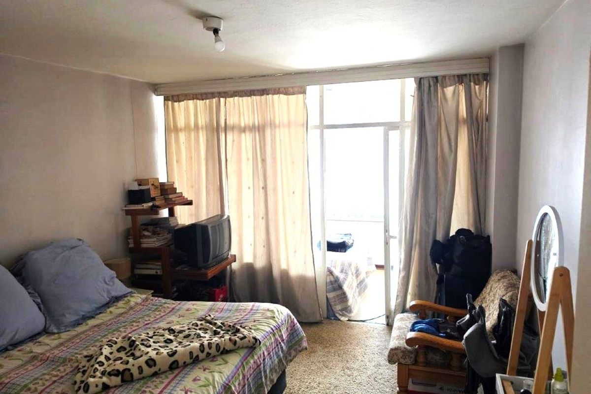 A bedroom featuring carpet flooring and a sliding glass door providing access to an outdoor area.