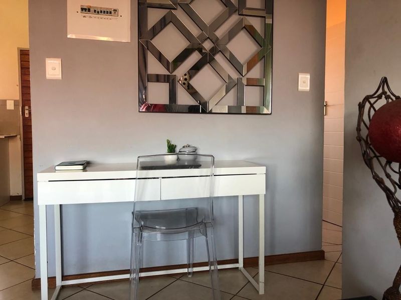 A functional hallway area featuring tiled flooring and neutral wall finishes, providing a transitional space within the apartment.
