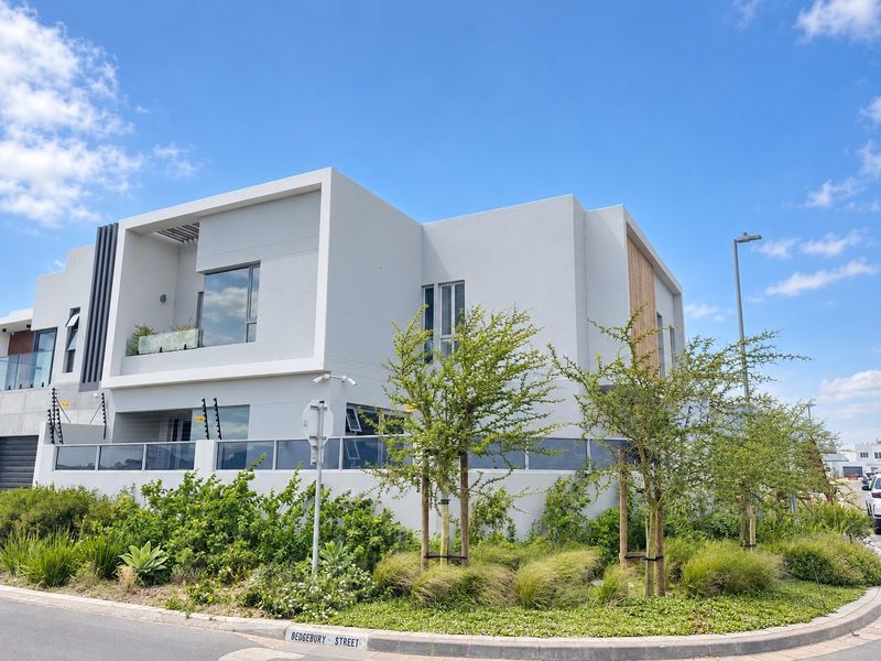 Modern two-story residential property featuring a contemporary facade with timber accents, glass balustrades, and well-maintained landscaped garden on a corner street plot.