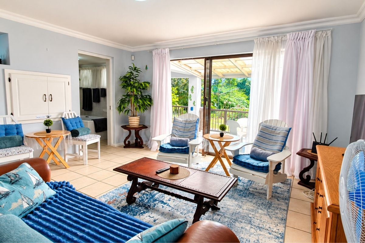 A bright and airy living room featuring tiled flooring, cove molding, and large sliding glass doors that provide direct access to the outdoor patio area.