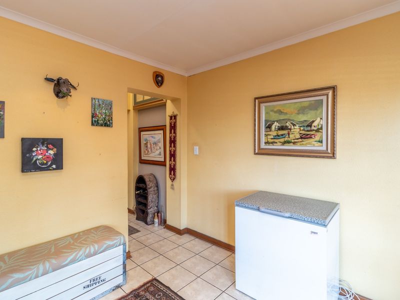 A functional hallway area featuring tiled flooring and neutral wall finishes, providing access to adjacent living spaces.