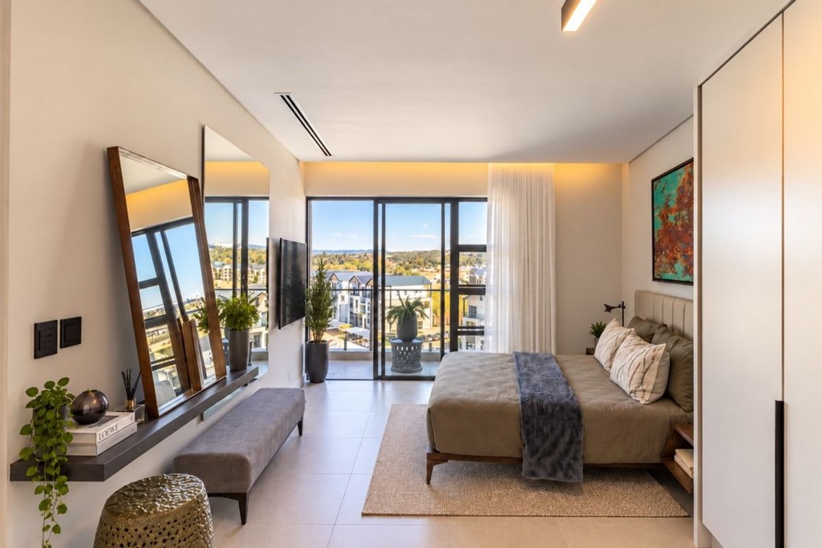 Modern penthouse bedroom featuring sleek tiled floors, built-in cabinetry, and large sliding glass doors opening to a private balcony with expansive views.