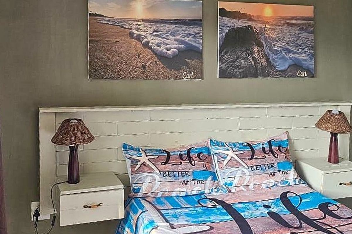 A bedroom featuring a white painted brick-style built-in headboard with integrated wall-mounted bedside tables.