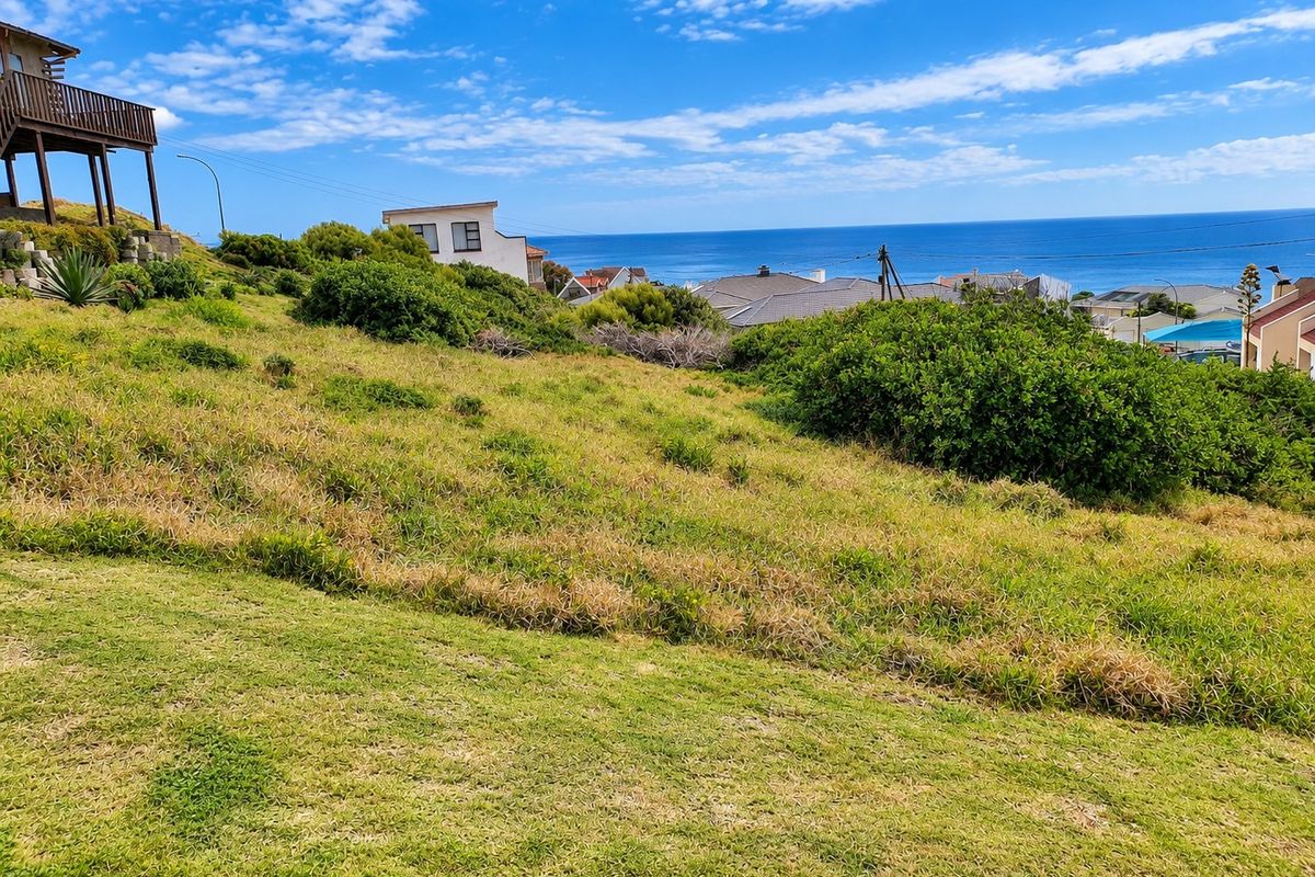 A sloped residential vacant land plot offering expansive ocean views and surrounding coastal neighborhood scenery.