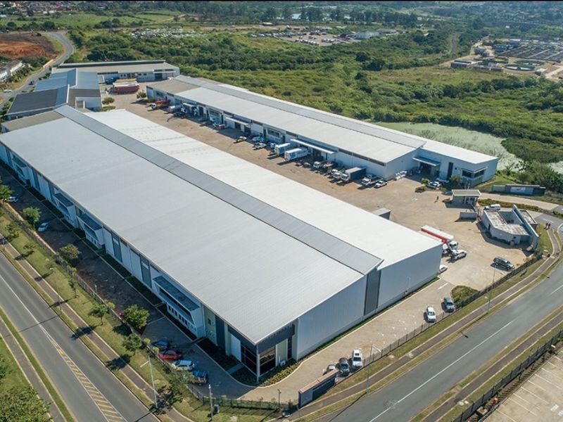 Aerial view of a large commercial industrial park featuring extensive warehouse facilities, loading bays, paved yard space, and secure perimeter access.