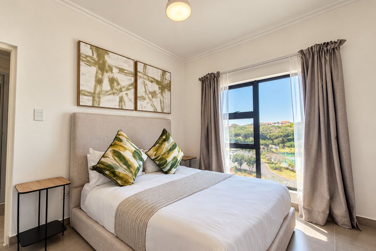 A well-maintained bedroom featuring tiled flooring, a ceiling fan, and a large window offering scenic outdoor views.