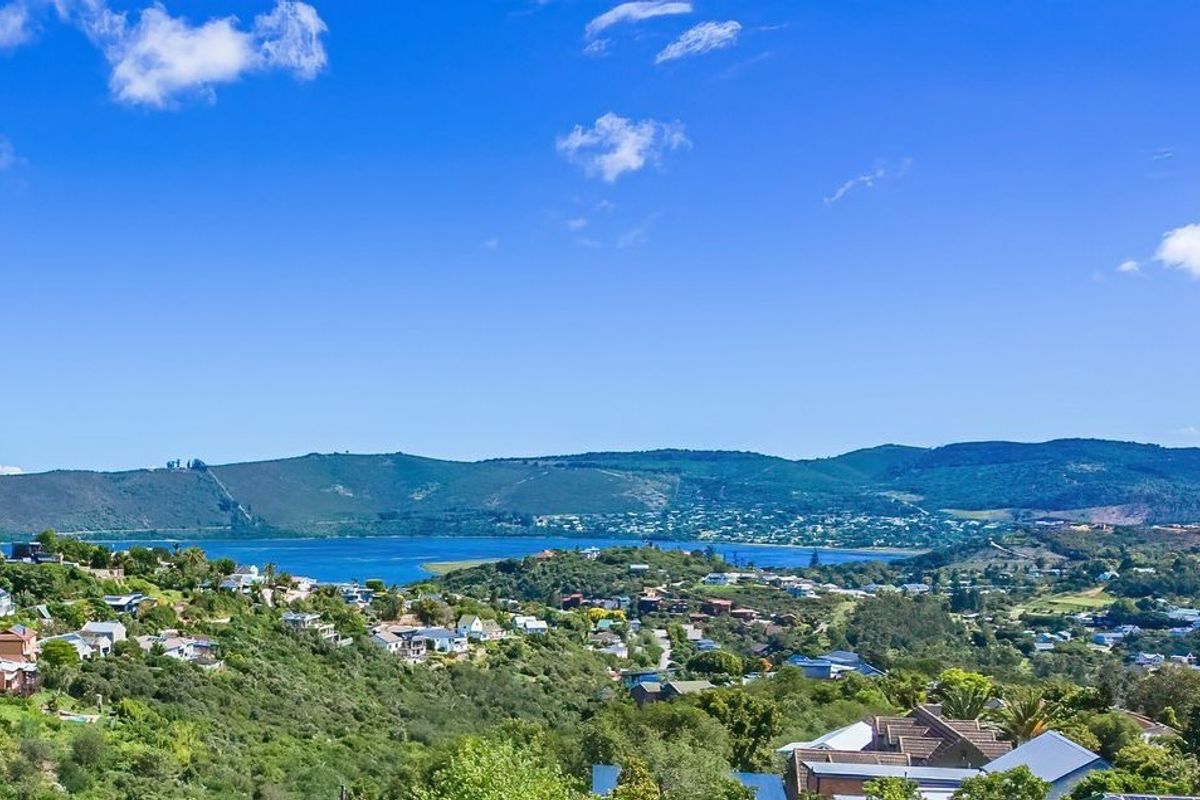 A scenic elevated view overlooking the surrounding residential landscape, hills, and the distant lagoon.