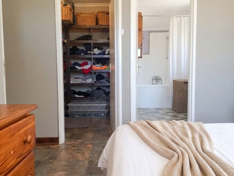 Bedroom featuring tiled flooring with direct access to a walk-in closet and an en-suite bathroom.