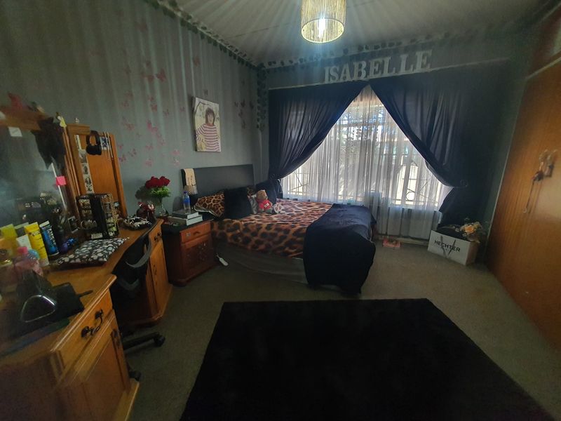 A bedroom featuring carpet flooring and a built-in wardrobe, offering a functional space with potential for modernization.