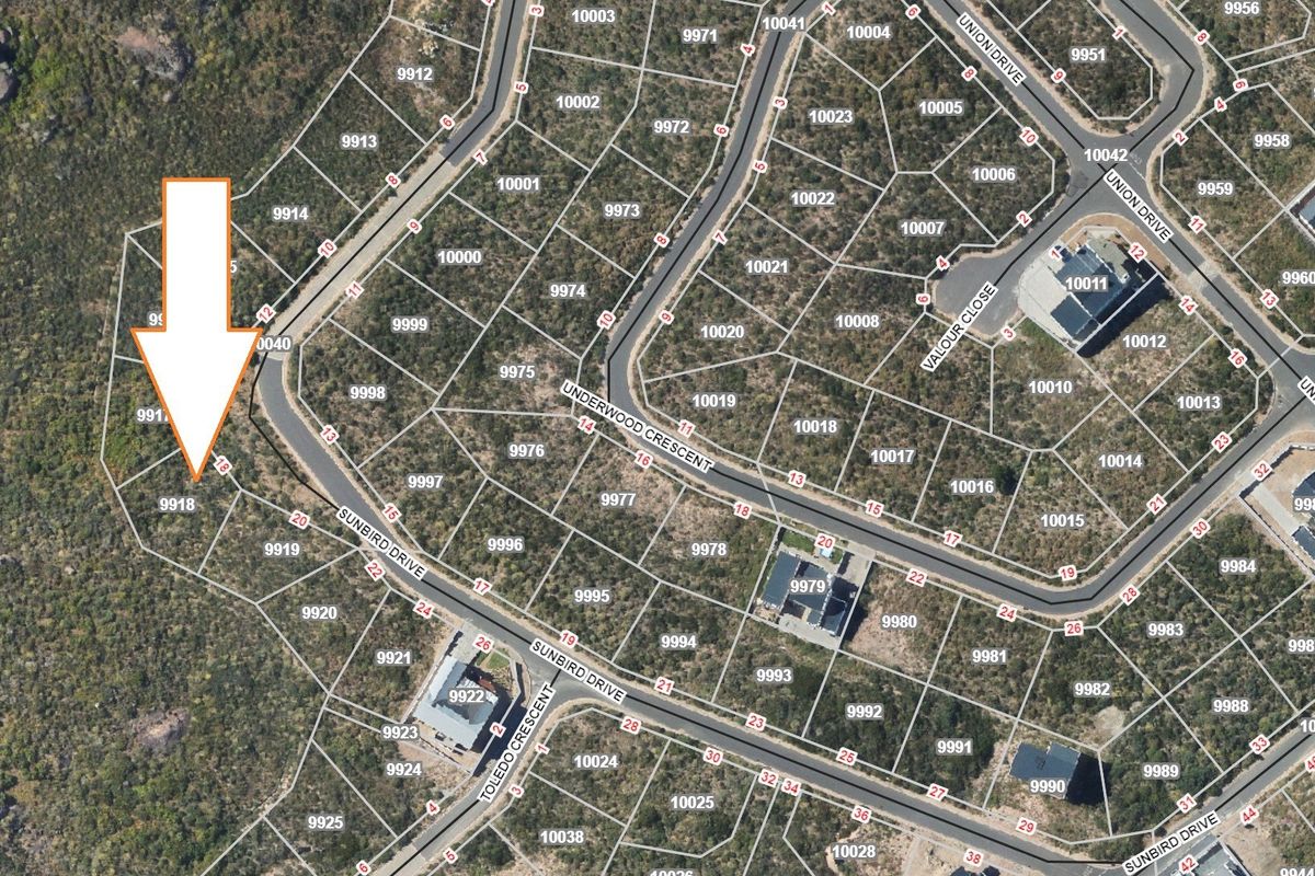 An aerial view of the residential estate showing the location of the vacant land plot marked with an arrow.
