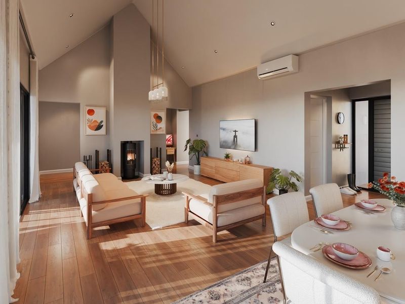Spacious open-plan living and dining area featuring vaulted ceilings, hardwood flooring, a modern fireplace, and split-system air conditioning with abundant natural light.
