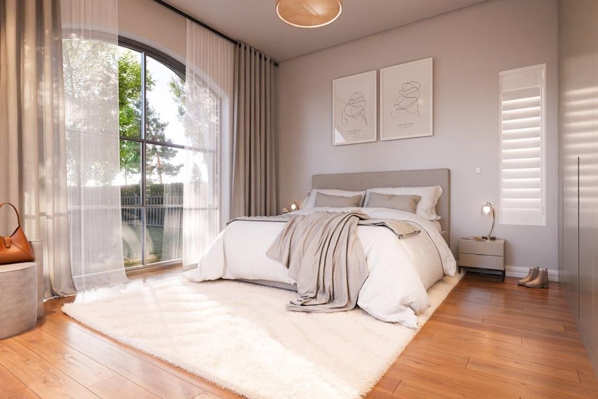 A bright and modern bedroom featuring elegant arched windows, warm hardwood flooring, and built-in storage solutions, creating a serene and inviting atmosphere.