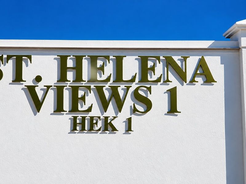 A clear view of the St. Helena Views 1 estate signage mounted on a well-maintained white boundary wall.