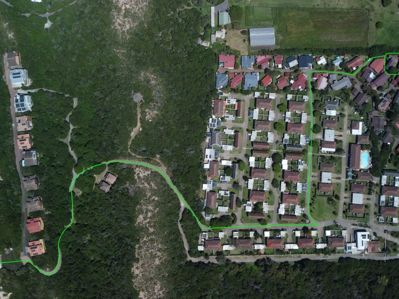 Aerial view of the residential estate showing the property location and the designated walking path providing direct access to the nearby beach.