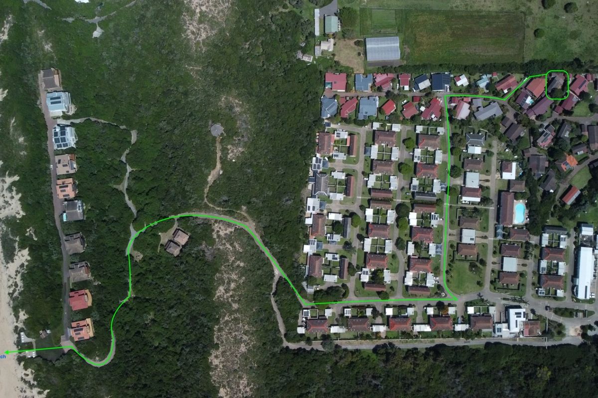 Aerial view of the residential estate showing the property location and the designated walking path providing direct access to the nearby beach.