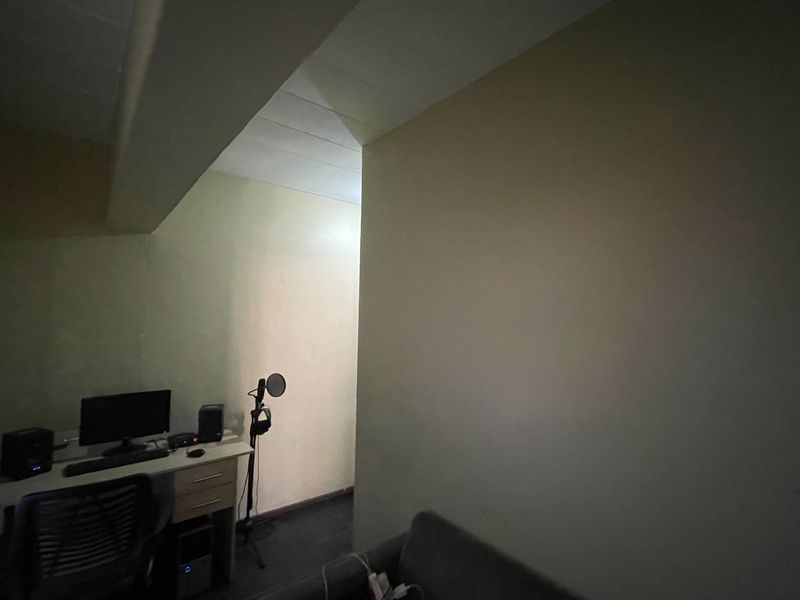 A functional home office space featuring a built-in desk area with neutral wall finishes.