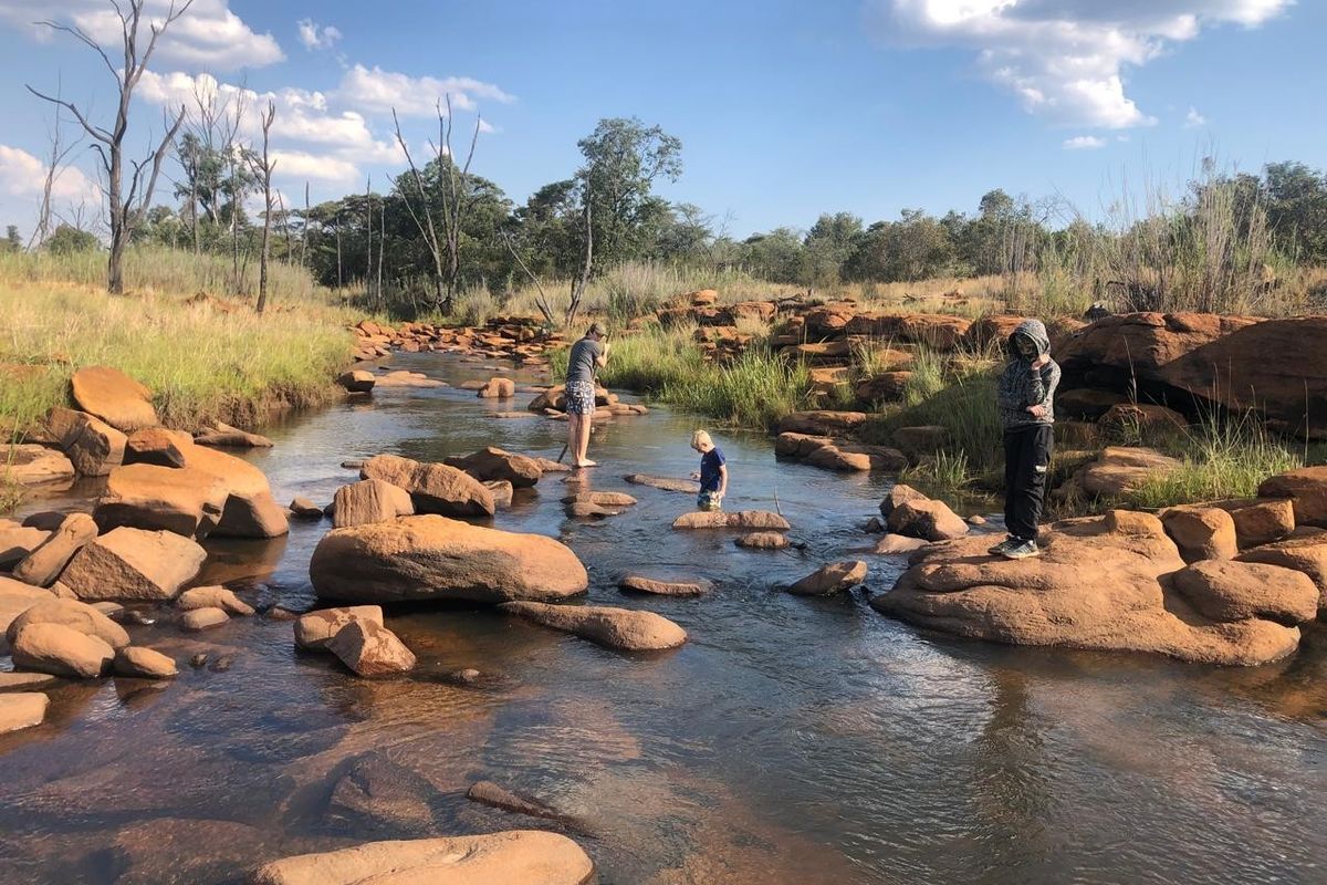 A scenic view of a natural stream flowing through rocky terrain on the property.
