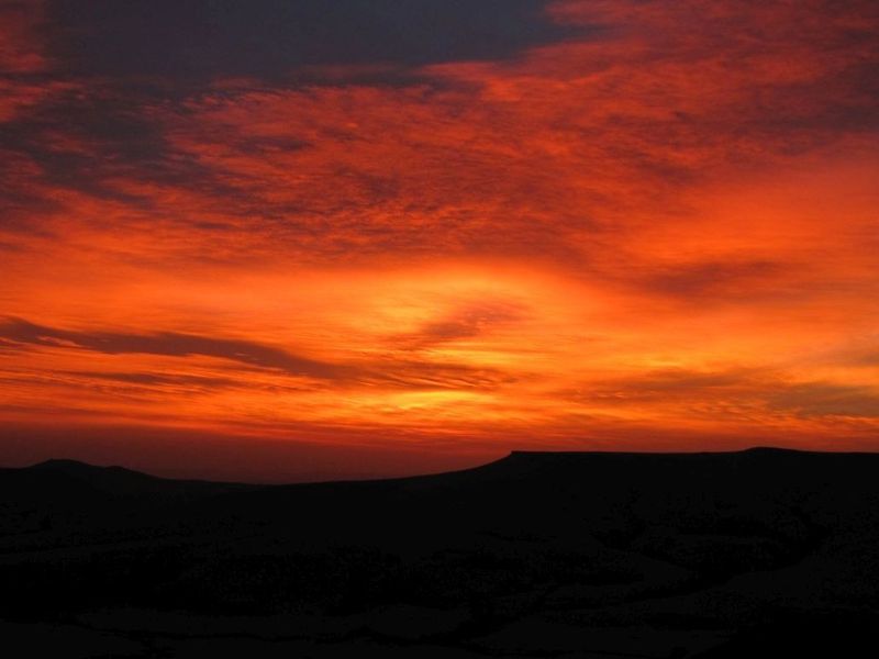 A scenic view of a vibrant sunset over the rural landscape.