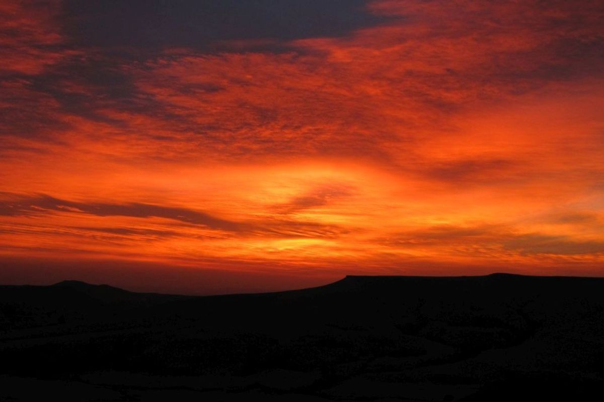 A scenic view of a vibrant sunset over the rural landscape.