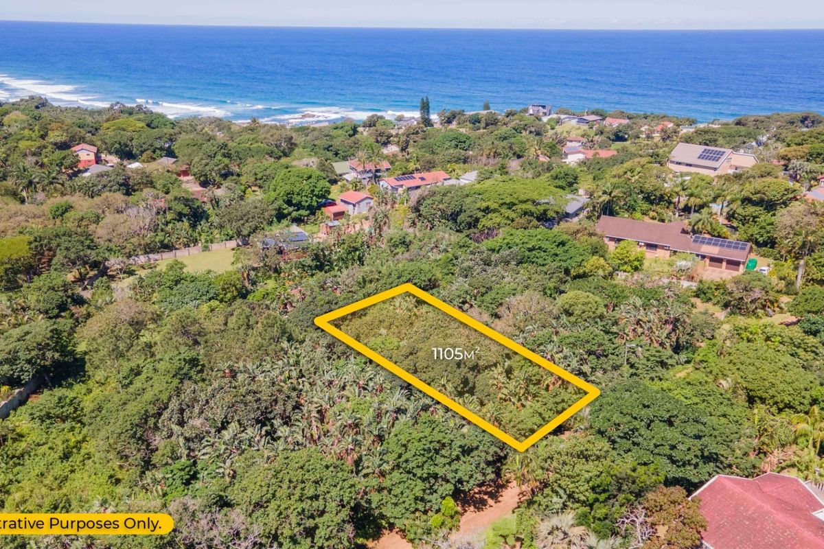 Aerial view of a 1105m² vacant residential plot situated in a lush coastal area with ocean views.