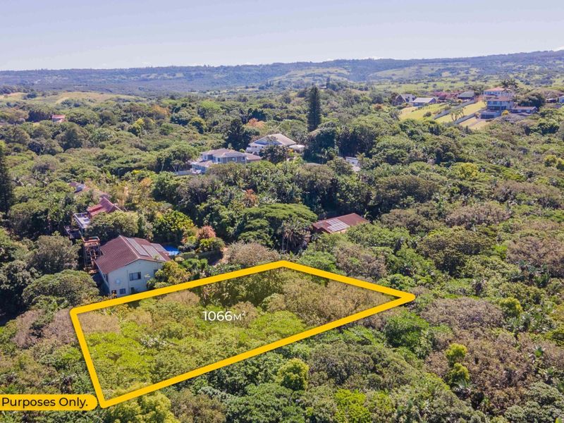 An aerial view of a 1066m2 vacant residential plot surrounded by lush indigenous vegetation in a established neighborhood.