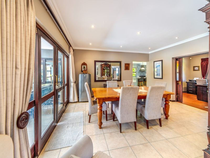 Spacious dining room featuring tiled flooring, recessed lighting, and large sliding glass doors that provide access to the outdoor area.