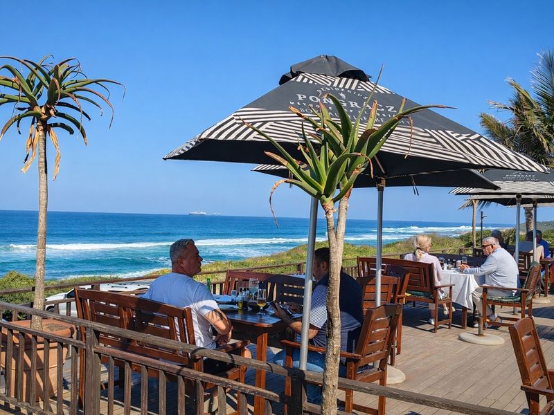 An elevated outdoor timber deck offering panoramic ocean views, featuring a durable wooden balustrade and open-air seating area.