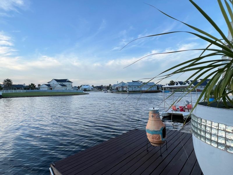 A scenic view overlooking the canal and surrounding estate homes from a private jetty.