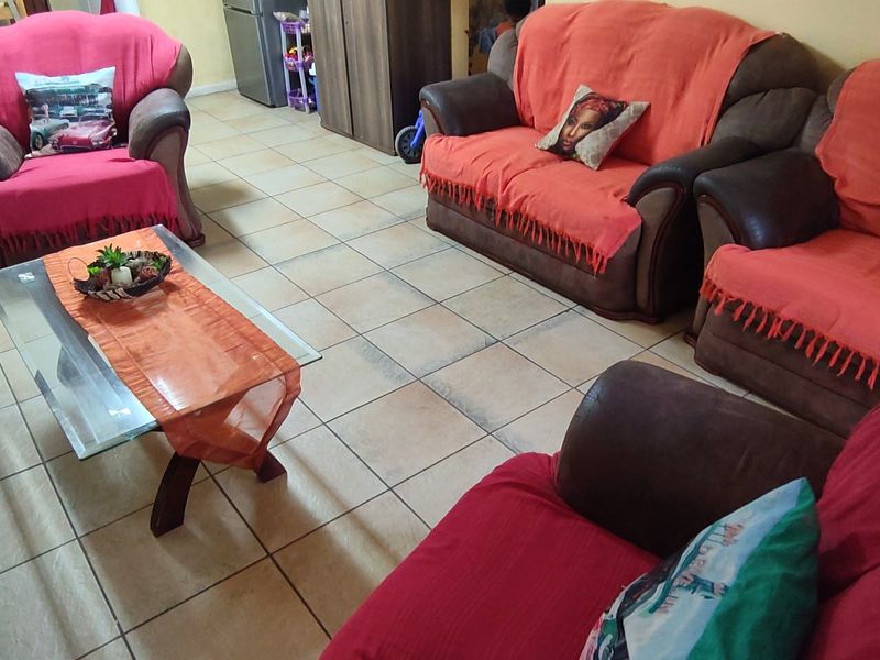 A living room area featuring neutral ceramic floor tiles throughout the space.
