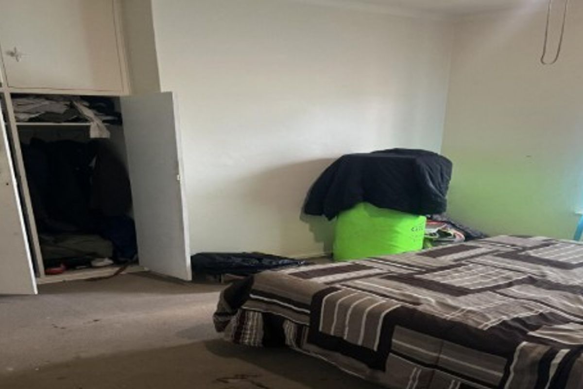 A bedroom featuring a built-in wardrobe and carpeted flooring, requiring cosmetic updates to improve the overall condition and appeal.