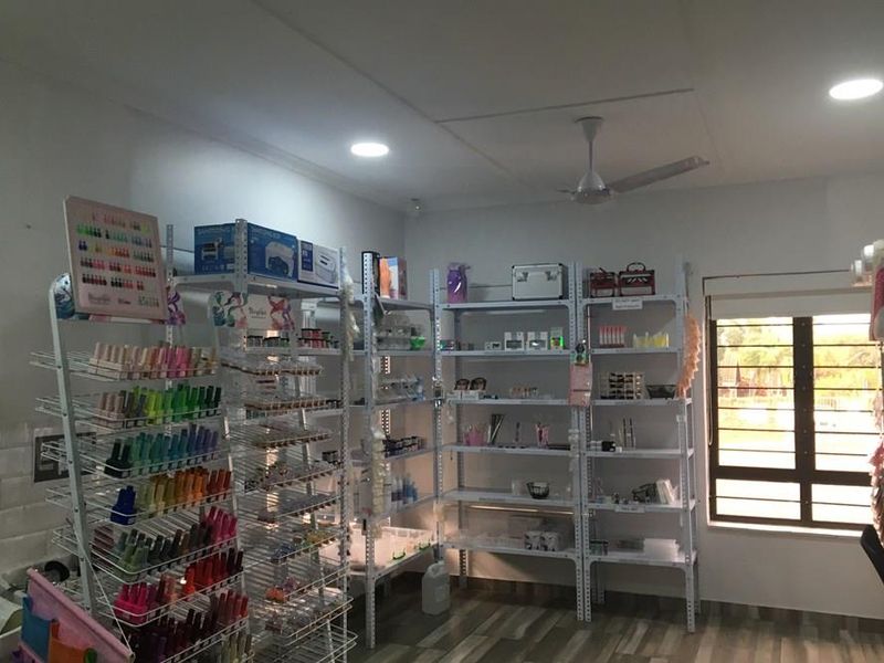 A functional commercial utility space featuring tiled flooring, recessed downlighting, a ceiling fan, and a window with security bars.
