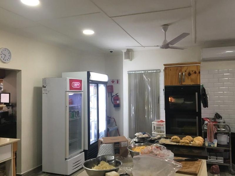 Commercial kitchen area featuring a built-in double oven, subway tile backsplash, recessed lighting, and integrated air conditioning unit.