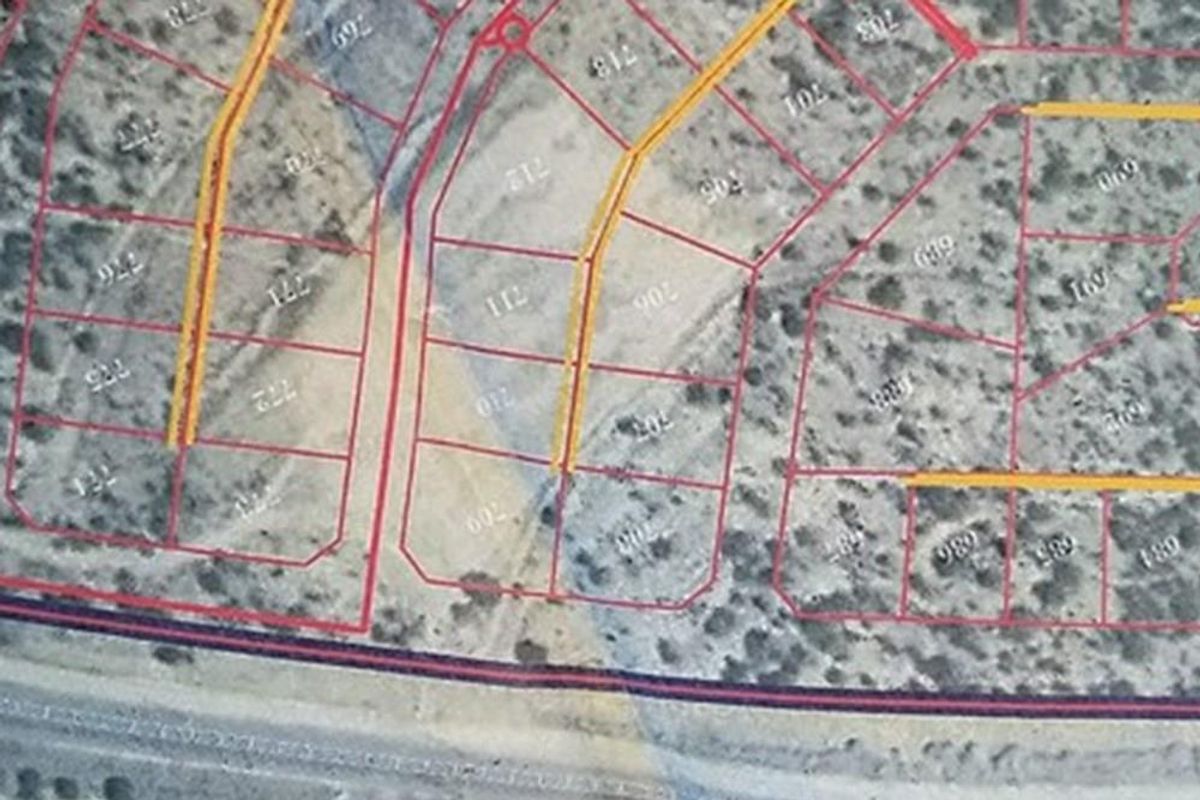 An aerial view showing the layout and boundaries of residential vacant land plots within the estate.