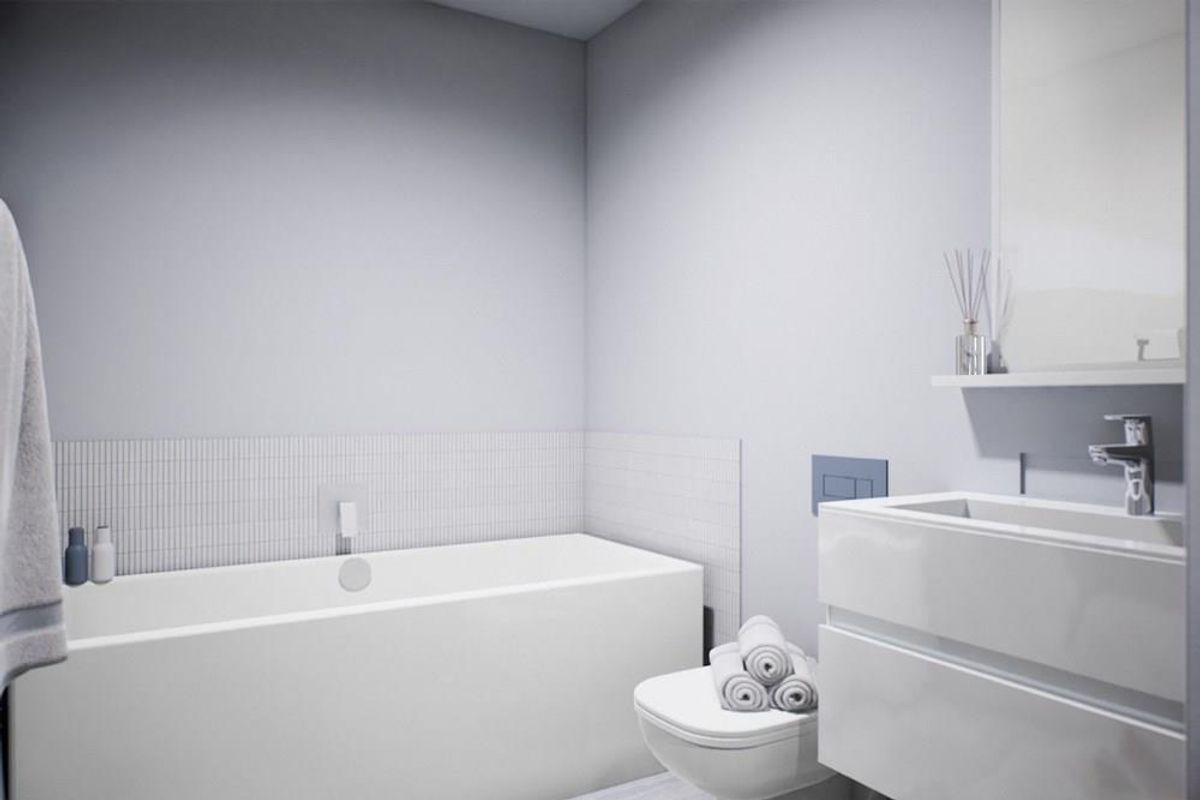 Modern bathroom featuring a sleek built-in bathtub, wall-mounted toilet with concealed cistern, and a contemporary vanity unit with integrated basin.