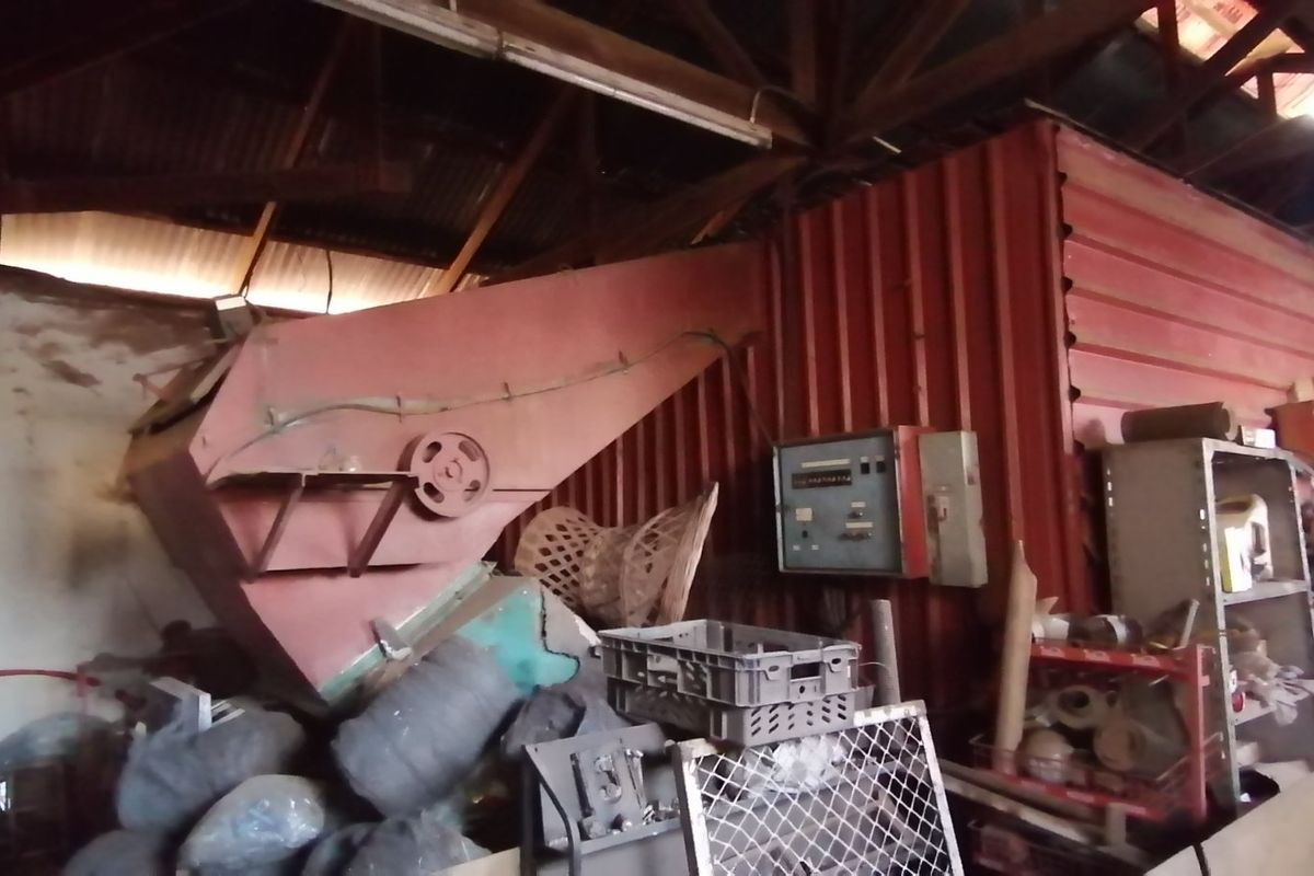 A large industrial utility space on the farm featuring heavy-duty processing machinery and exposed timber roof trusses.