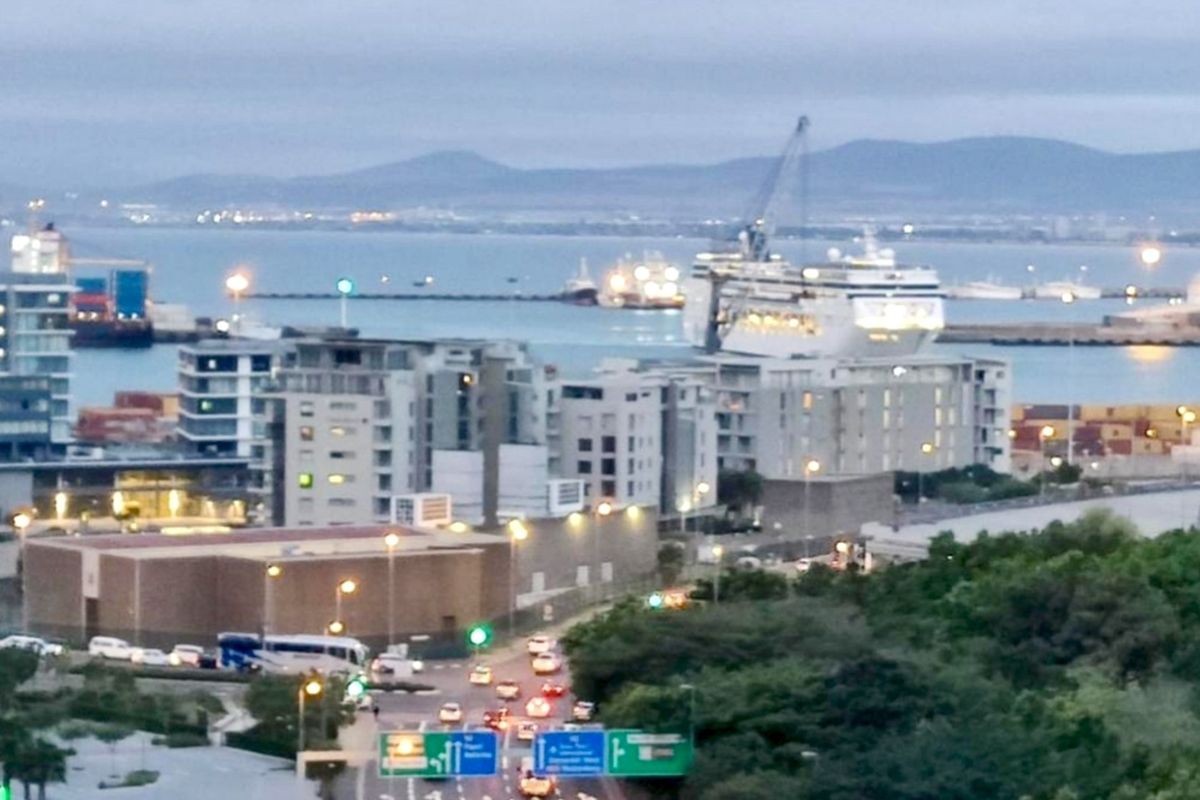 Elevated urban view overlooking the harbour, shipping vessels, and surrounding city infrastructure.
