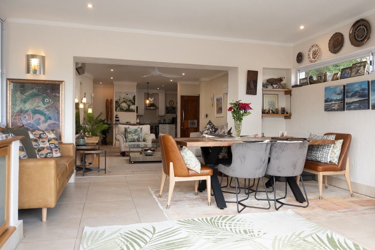 Spacious open-plan living and dining area featuring tiled floors, recessed lighting, and a seamless flow into the kitchen space.