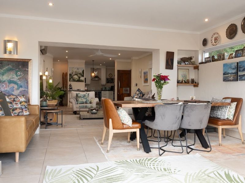 Spacious open-plan living and dining area featuring tiled floors, recessed lighting, and a seamless flow into the kitchen space.