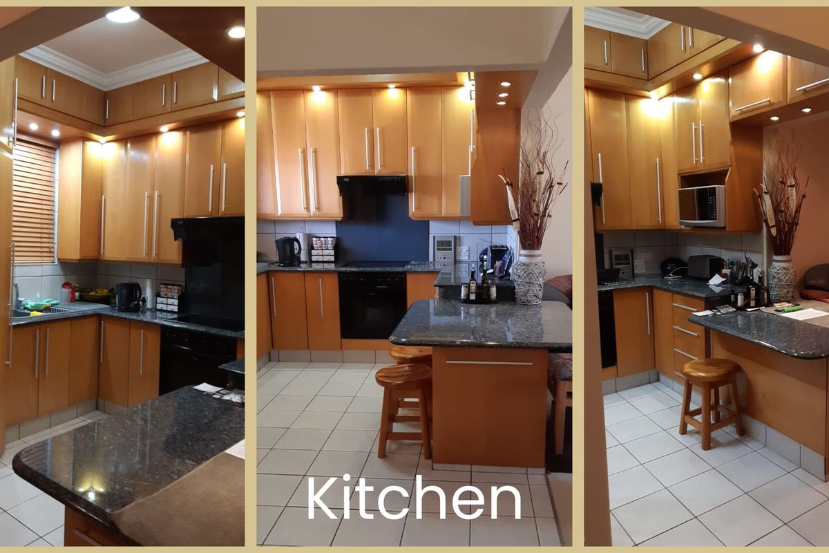 A functional kitchen featuring wood-finish cabinetry, granite countertops, integrated appliances, and tiled flooring with a breakfast bar area.