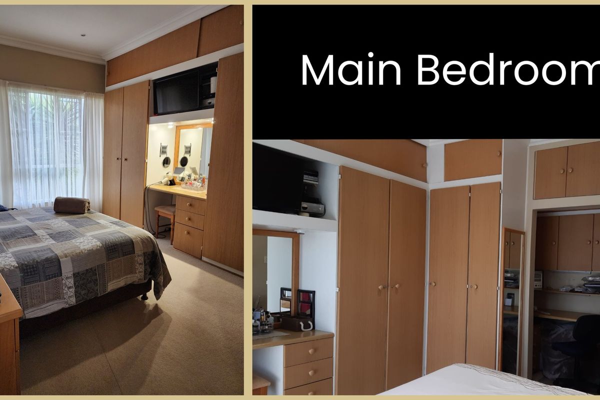 Main bedroom featuring extensive built-in wooden cabinetry, integrated vanity station, and neutral carpeting.