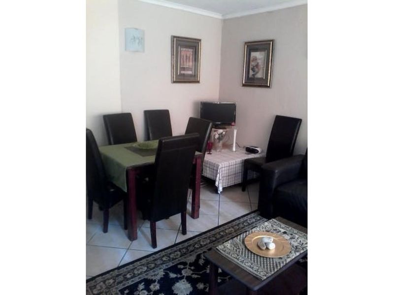 A dining area featuring tiled flooring, providing a functional space for meals and gatherings.