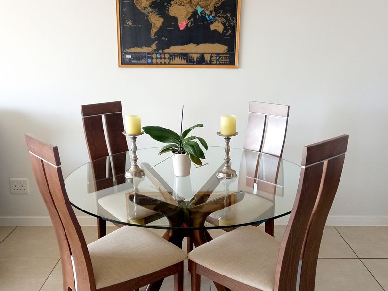 A well-lit dining area featuring neutral tiled flooring and a clean, minimalist aesthetic suitable for casual meals.