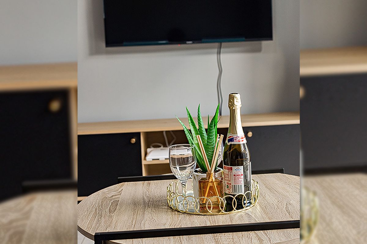 A modern living area featuring a wall-mounted television and sleek built-in cabinetry with a contemporary finish.