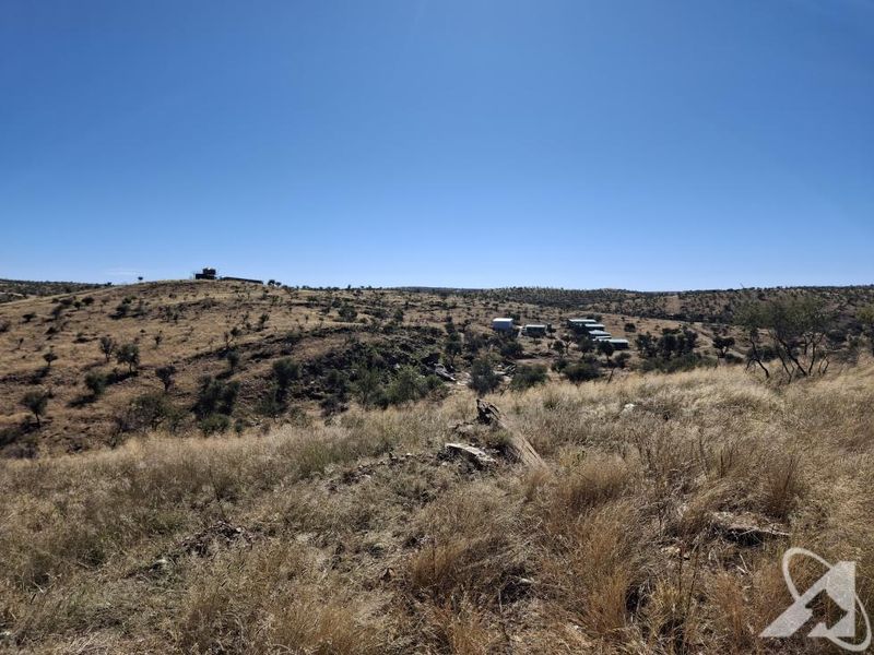 A wide-angle view of the expansive natural landscape and open veld characteristic of the small holding property.