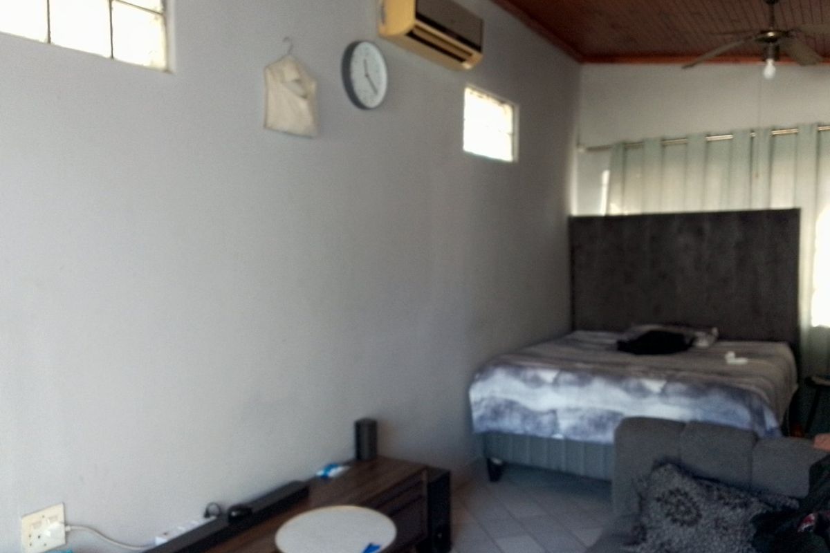 A bedroom featuring tiled flooring, a timber ceiling, a ceiling fan, and a wall-mounted air conditioning unit.