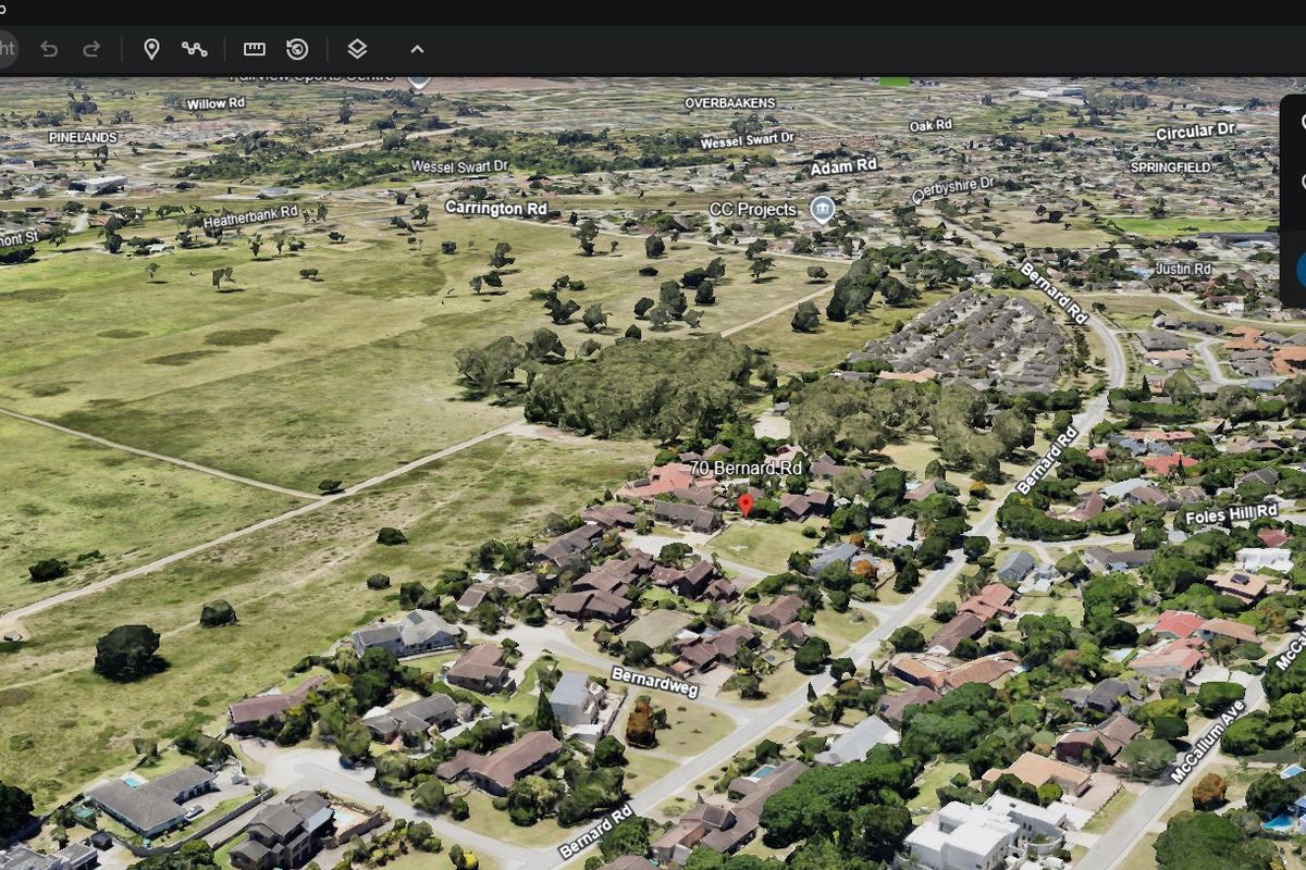 An aerial view of the residential property located at 70 Bernard Road, showing the surrounding neighborhood and landscape.