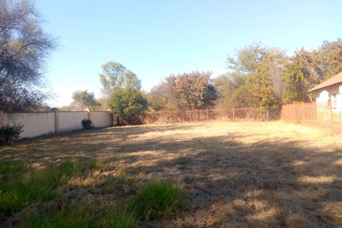 A spacious, level residential plot featuring established perimeter walling and metal fencing, offering a blank canvas for landscaping or future development.