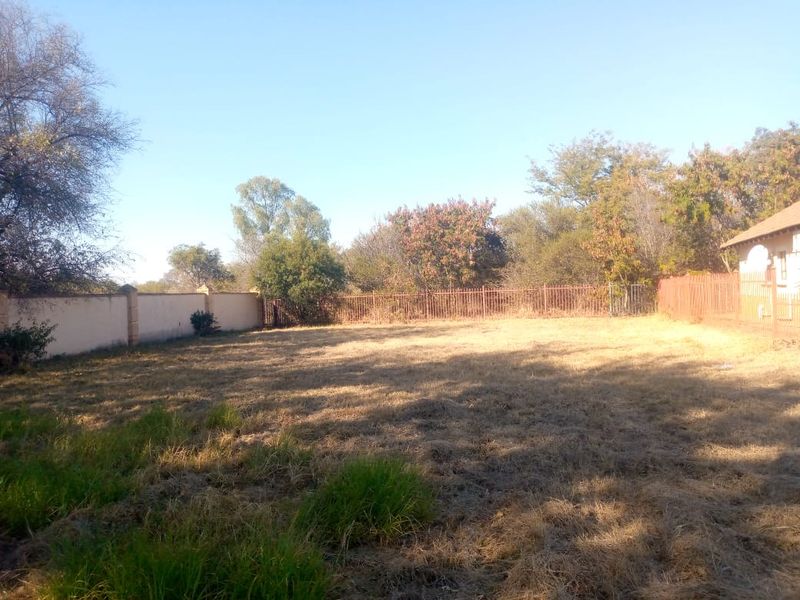 A spacious, level residential plot featuring established perimeter walling and metal fencing, offering a blank canvas for landscaping or future development.