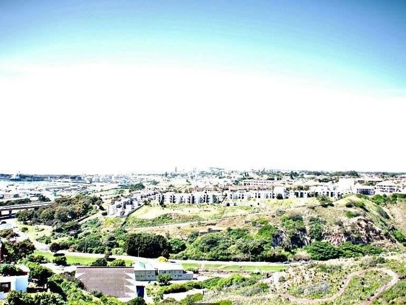 An elevated panoramic view overlooking the surrounding neighborhood, coastal landscape, and urban infrastructure.