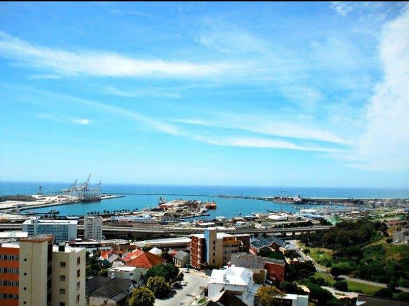 Elevated panoramic view overlooking the harbor, coastline, and surrounding urban landscape.